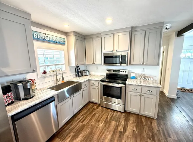 a living room with a couch and a wooden floor