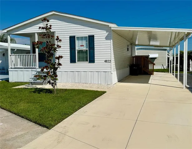 a front view of a house with a garden and yard
