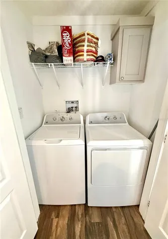 a view of a bedroom with wooden floor and small space
