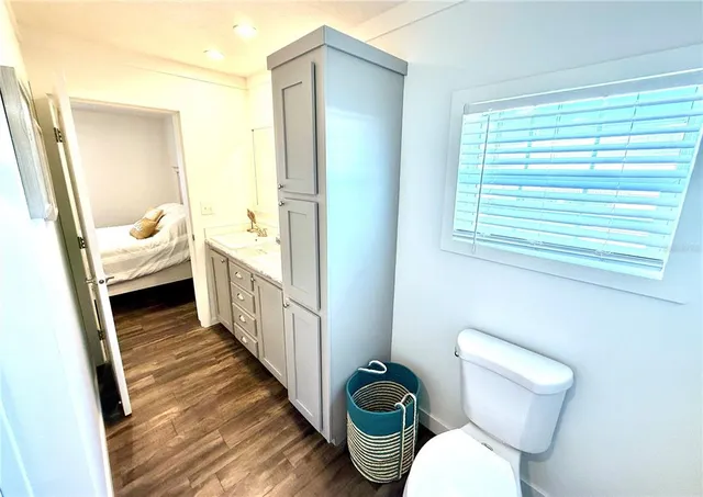 a bed sitting in a bedroom next to a window