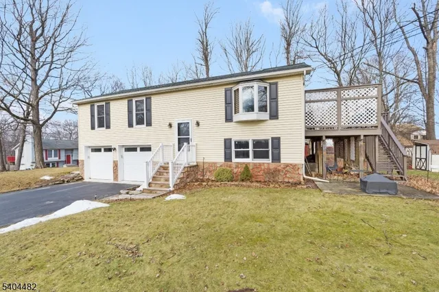 a view of a house with a yard covered in snow