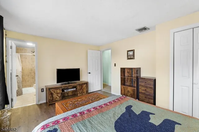 a bedroom with a bed and a flat screen television