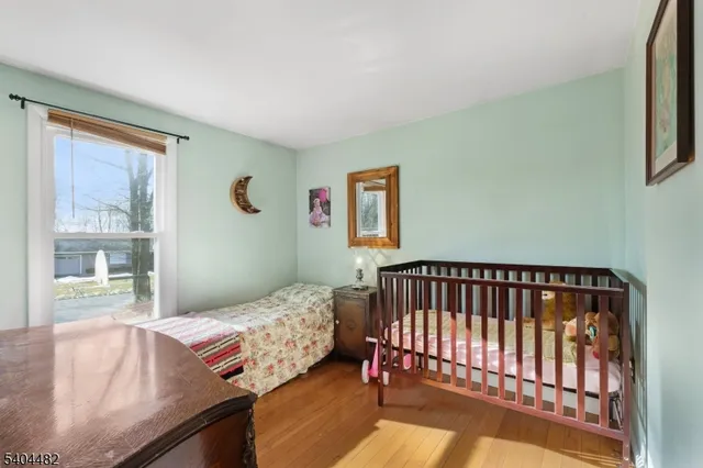 a bed sitting in a bedroom next to a window