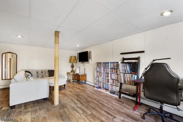 a living room with furniture and a book shelf