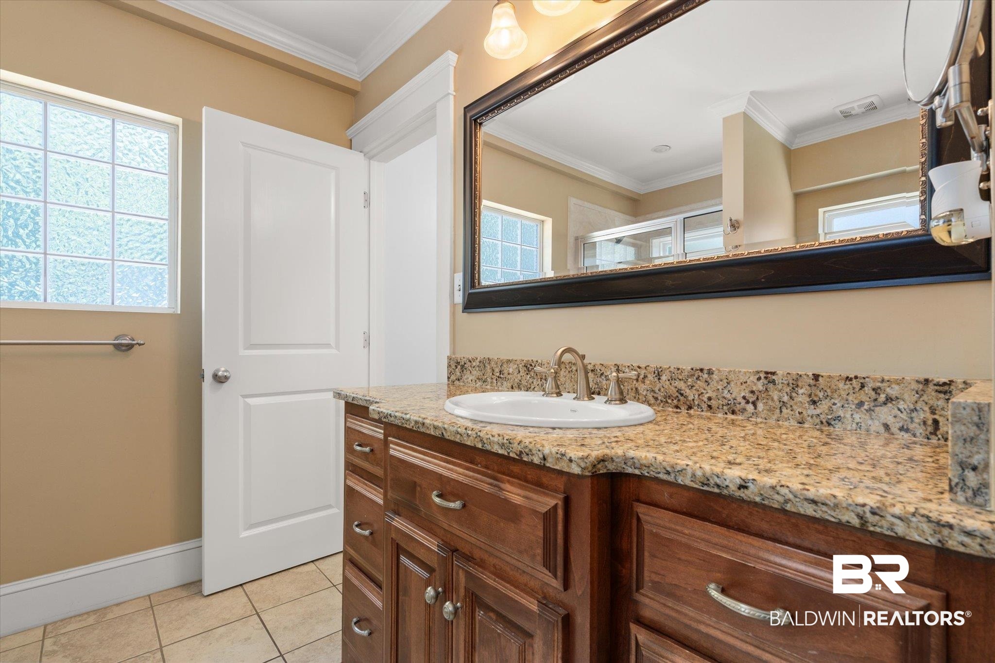 24 Macy Place Mobile, AL 36604 - Photo 25 of 38 Bathroom featuring vanity, tile patterned floors, crown molding, baseboards, and a shower with shower door
