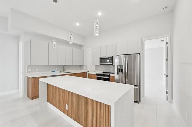 an empty room with fan and entrance