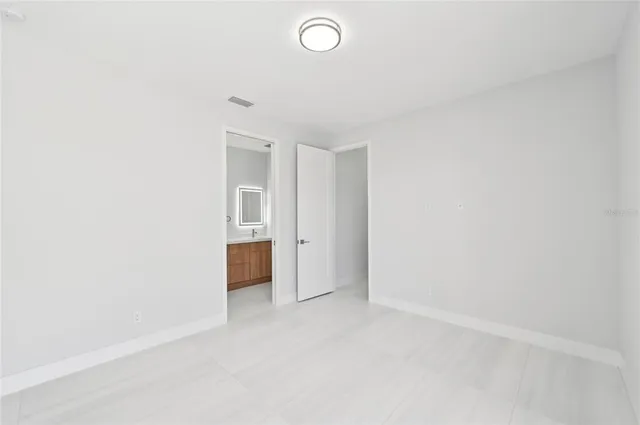 a view of walk in closet with empty racks