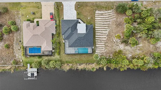 a view of residential houses with outdoor space and lake view