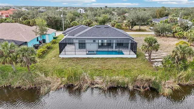 a view of a swimming pool with a bench and lawn chairs