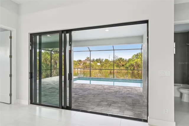 a large white kitchen with a large window
