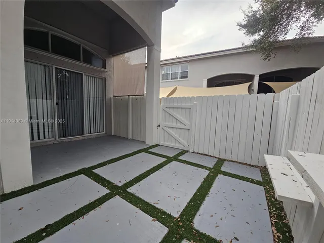 a backyard of a house with table and chairs