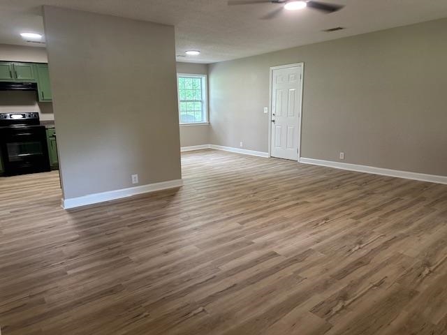 15 Brookwood Loop Adamsville, TN 38310 - Photo 4 of 21 an empty room with wooden floor and windows