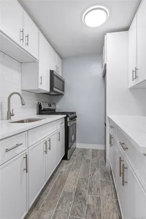 a kitchen with cabinets a sink and appliances