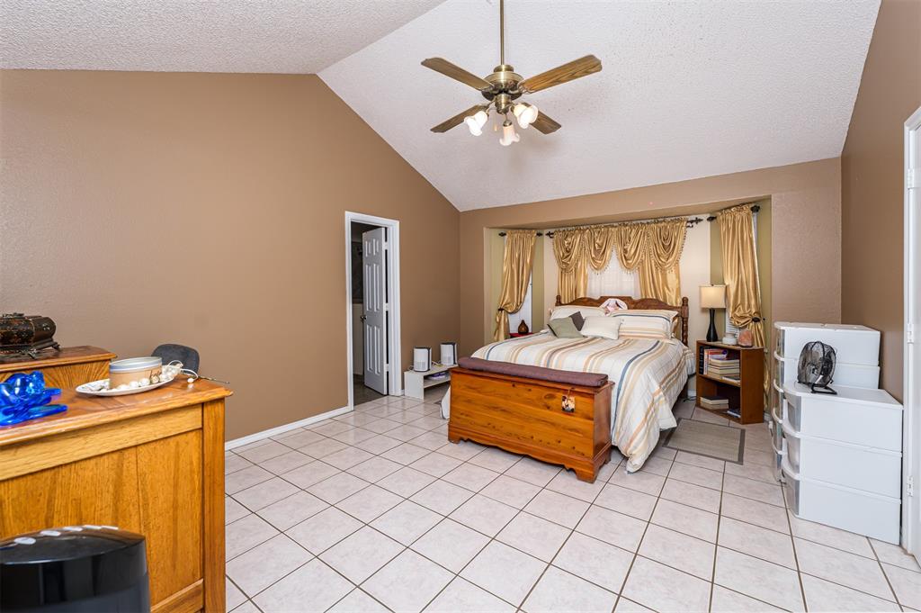 601 Houston School Road Red Oak, TX 75154 - Photo 8 of 32 Vaulted ceiling with a brass-finish ceiling fan, recessed bay window, and tile flooring