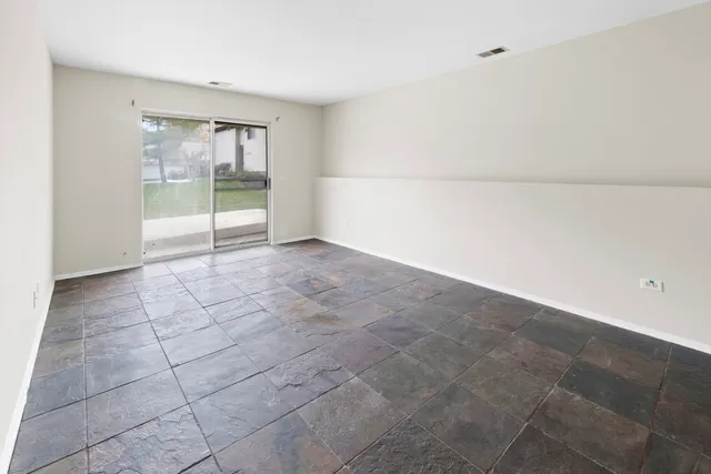 a view of an empty room with glass door