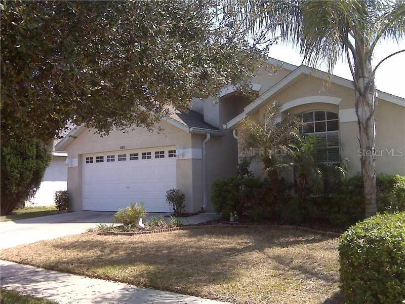 16831 Hawkridge Road Lithia, FL 33547 - Photo 1 of 1 a front view of a house with a yard and garage