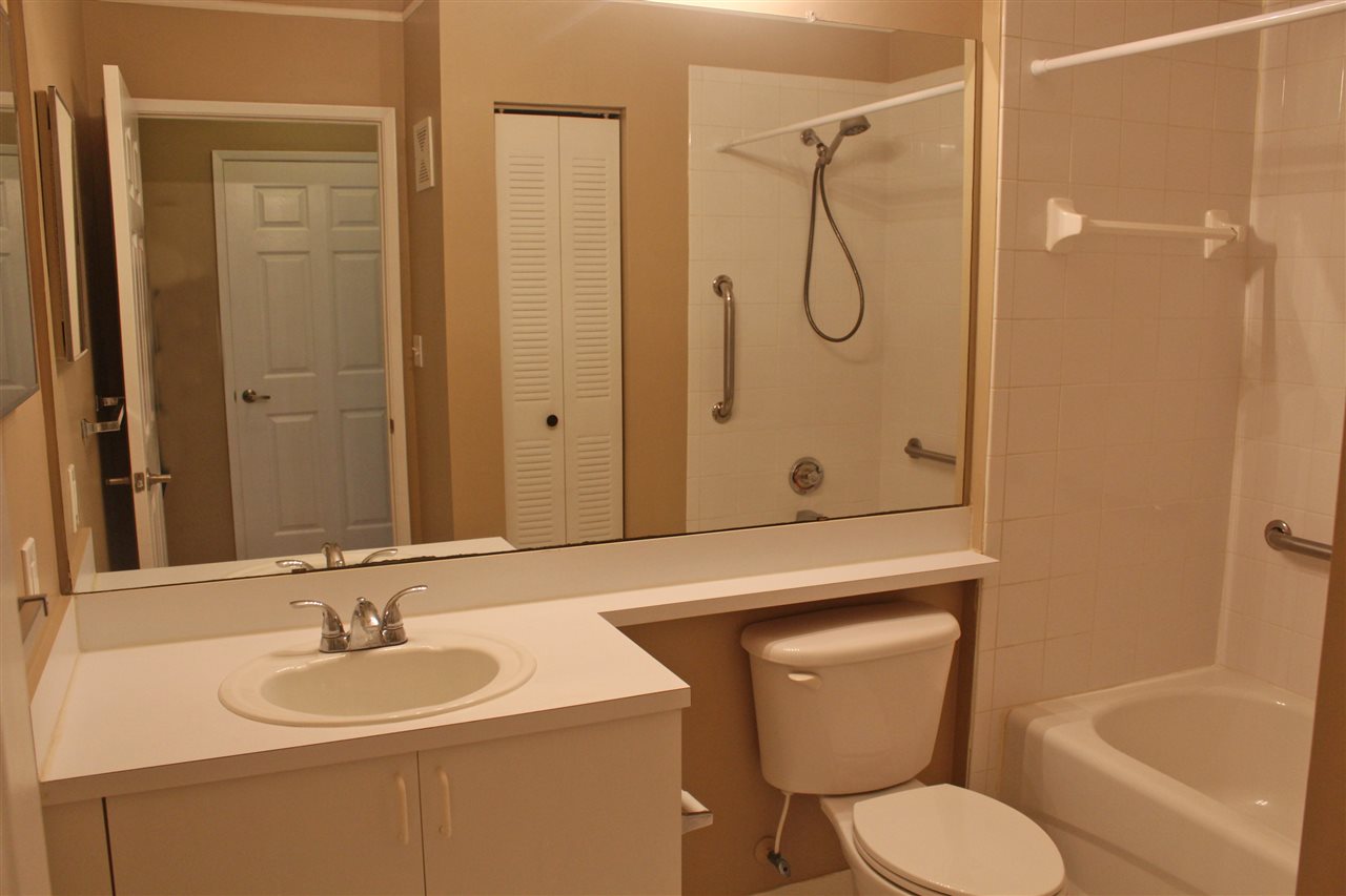 520 Florida Club Boulevard, Unit 103 St. Augustine, FL 32084 - Photo 17 of 26 a bathroom with a granite countertop toilet sink shower and mirror