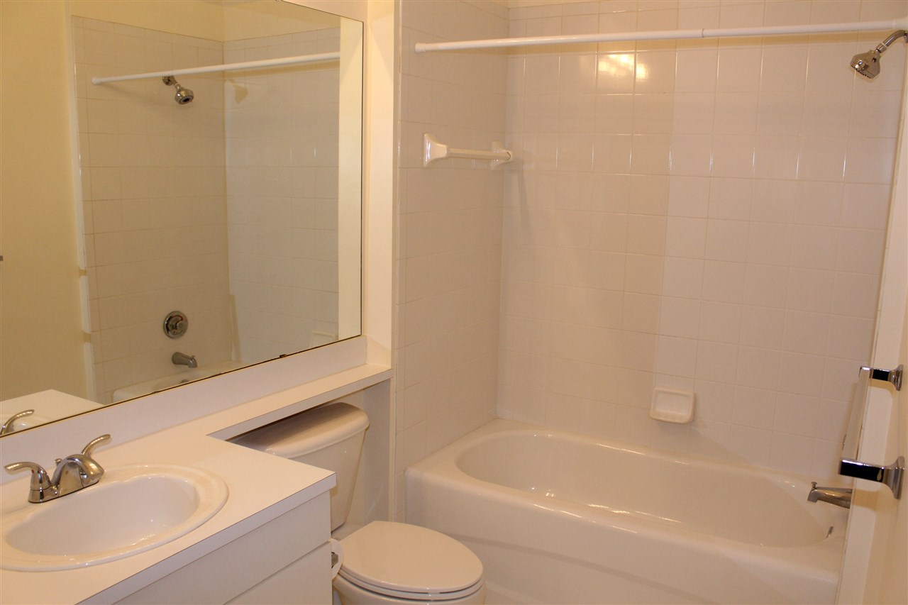 520 Florida Club Boulevard, Unit 103 St. Augustine, FL 32084 - Photo 20 of 26 a bathroom with a sink a toilet and shower