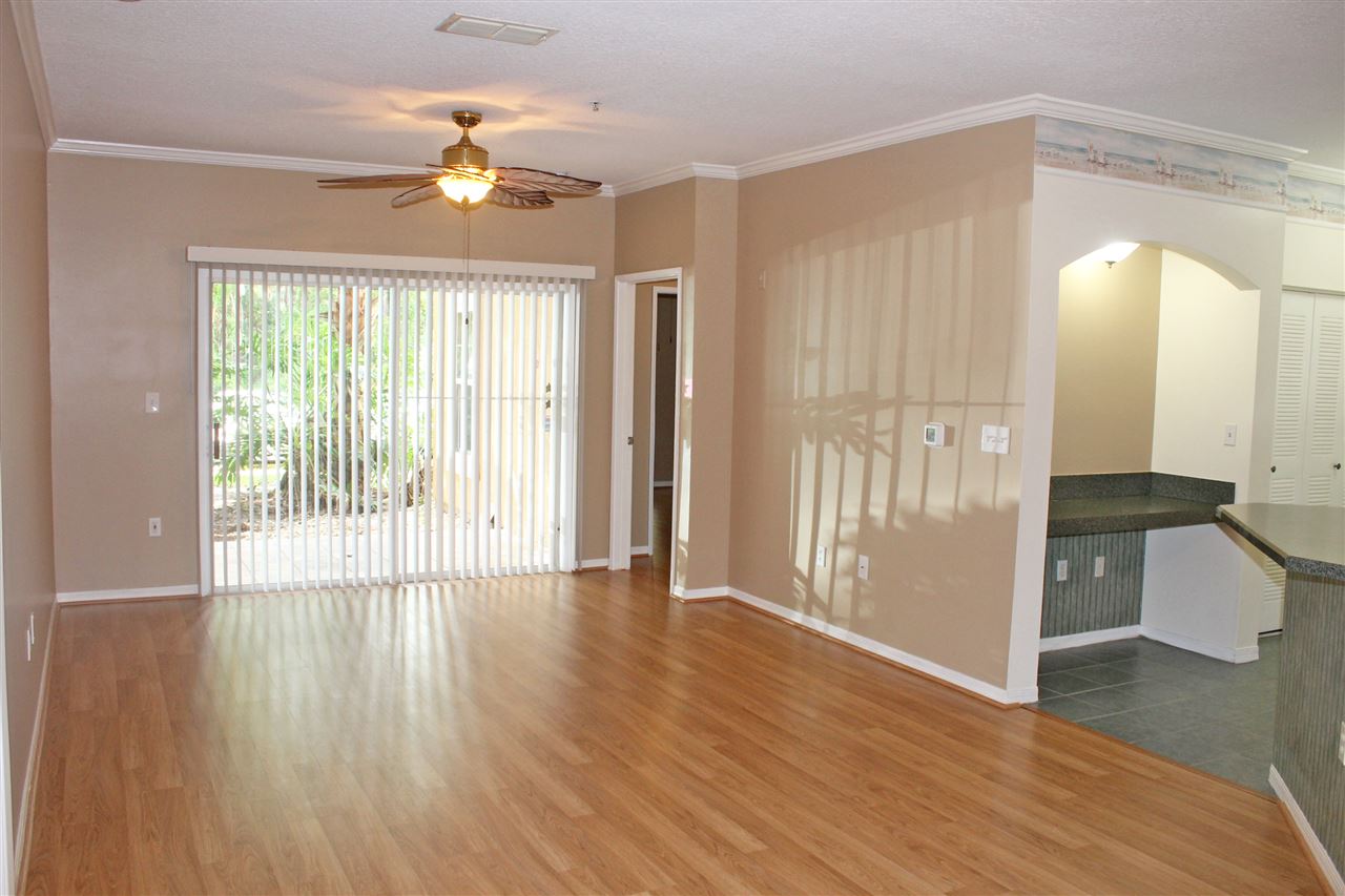 520 Florida Club Boulevard, Unit 103 St. Augustine, FL 32084 - Photo 4 of 26 a view of an empty room with wooden floor and a window