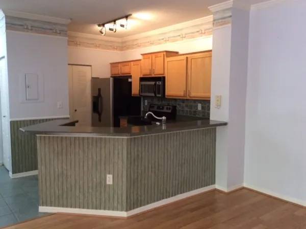 a view of kitchen and wooden floor