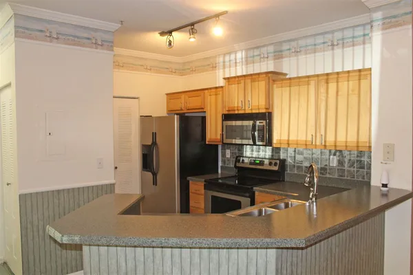 a kitchen with a sink and a refrigerator