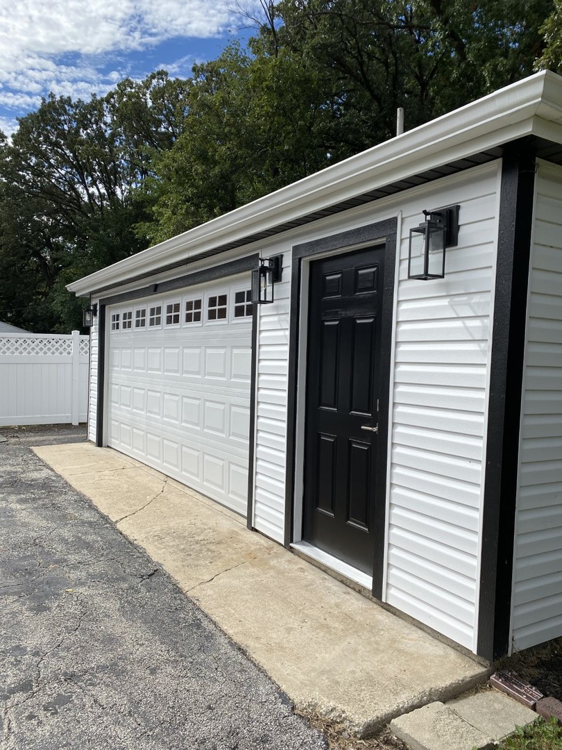 242 Highland Road Willowbrook, IL 60527 - Photo 3 of 24 a front view of a house with a garage
