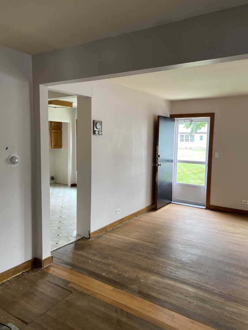 242 Highland Road Willowbrook, IL 60527 - Photo 6 of 24 a view of empty room with wooden floor and fan