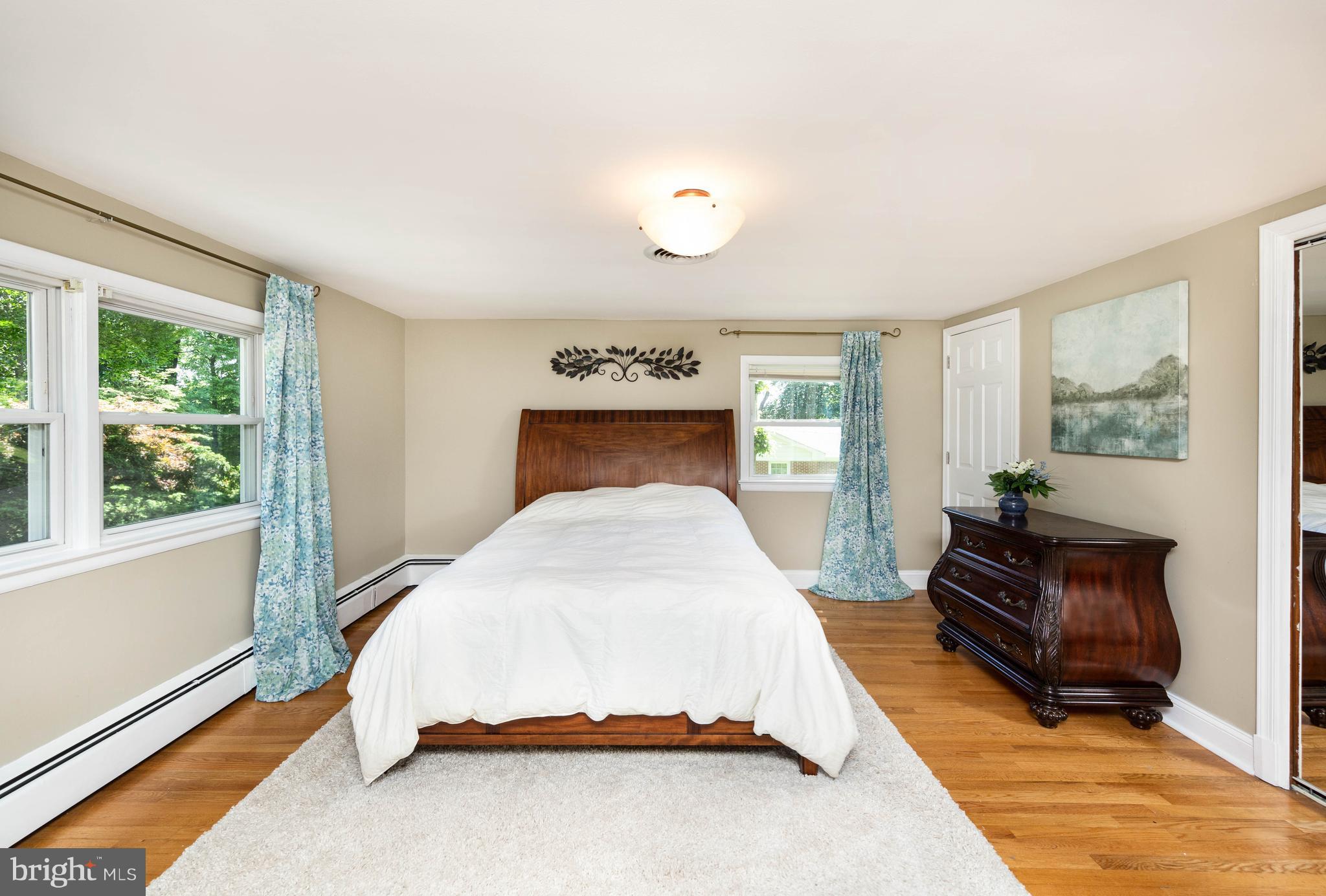 413 Whitaker Mill Road Fallston, MD 21047 - Photo 13 of 28 a bedroom with a bed and wooden floor