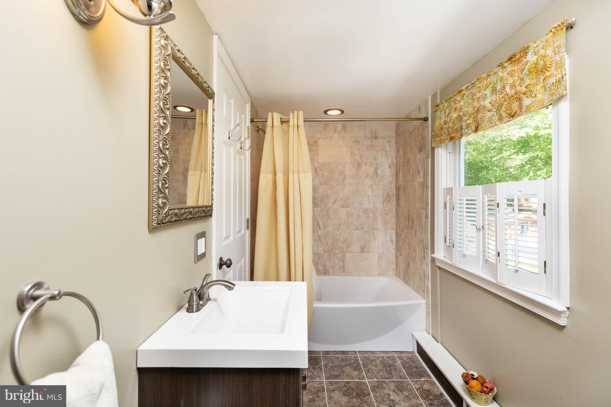 413 Whitaker Mill Road Fallston, MD 21047 - Photo 15 of 28 a bathroom with a bathtub shower sink and mirror
