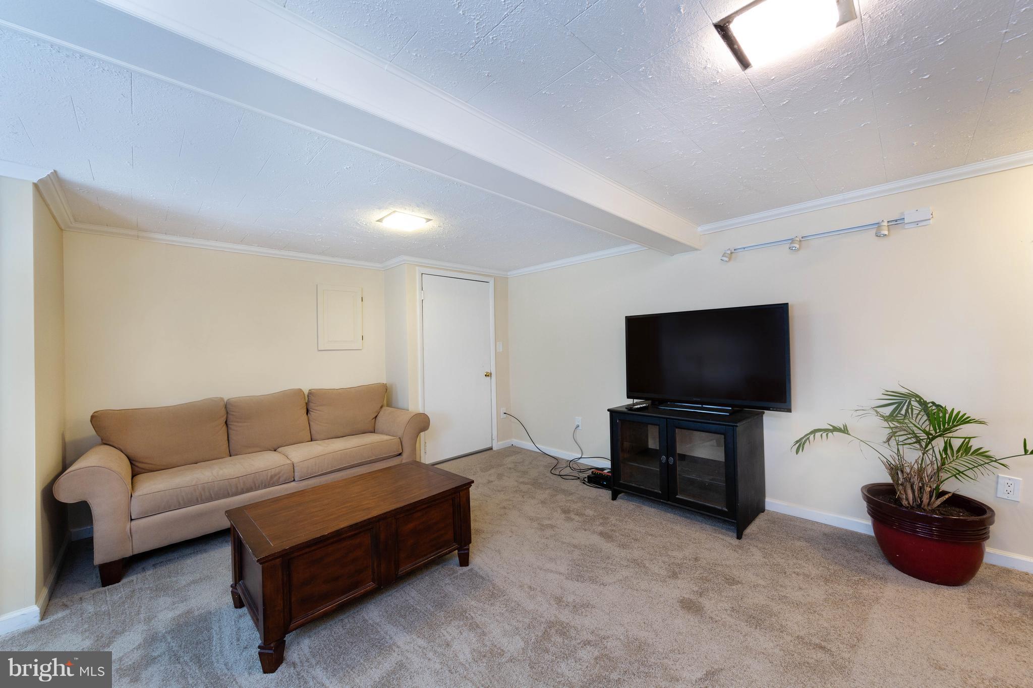413 Whitaker Mill Road Fallston, MD 21047 - Photo 21 of 28 a living room with furniture and a flat screen tv