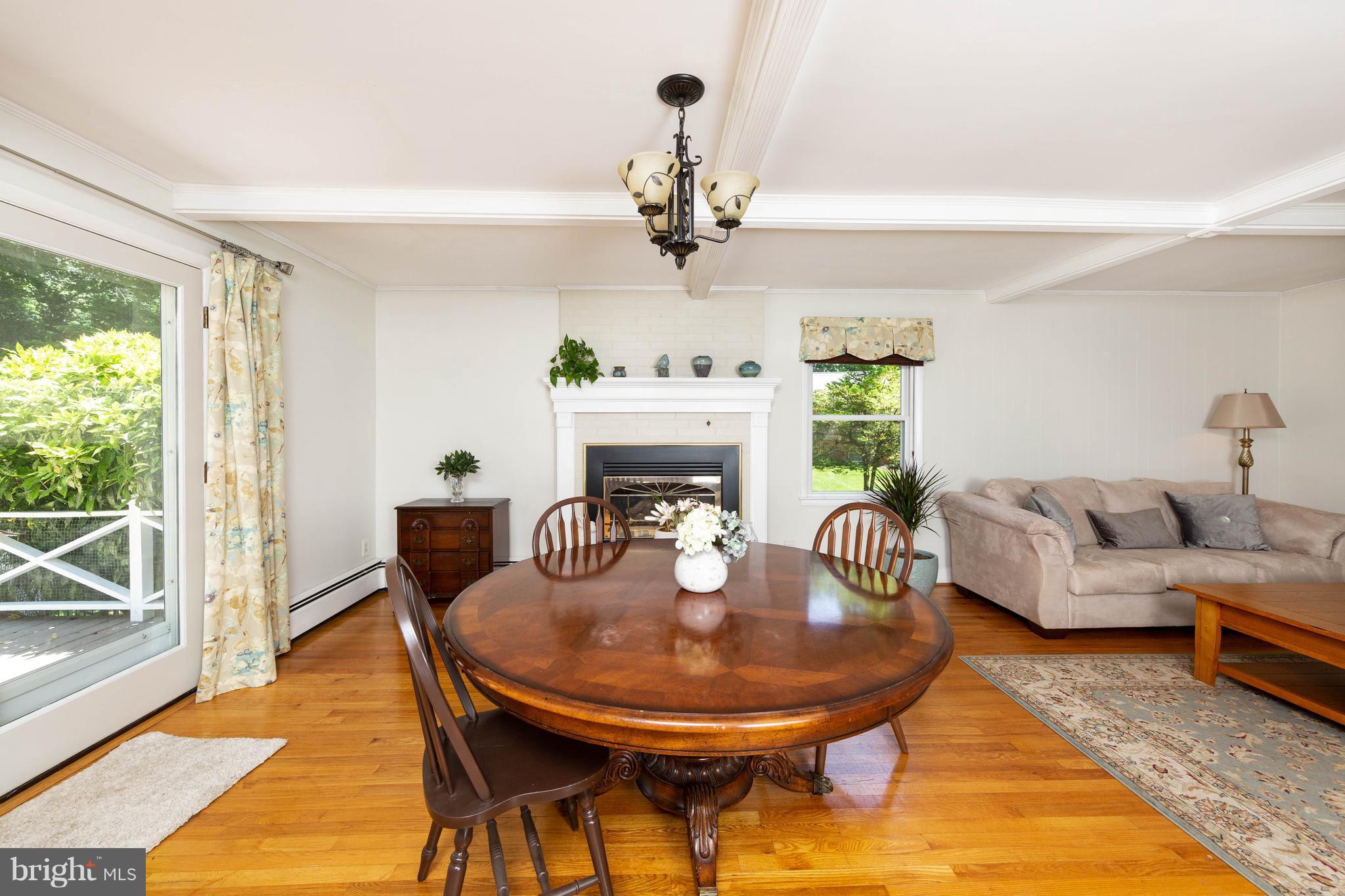 413 Whitaker Mill Road Fallston, MD 21047 - Photo 7 of 28 a living room with furniture a chandelier and a fireplace