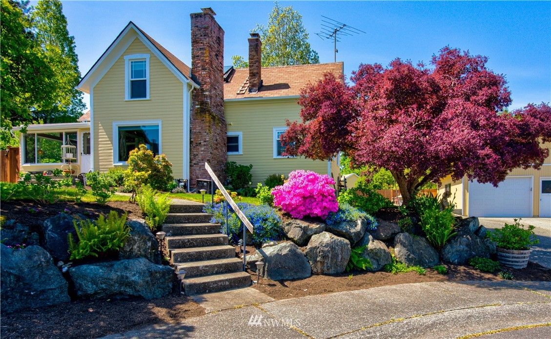 23908 24th Drive Southeast Bothell, WA 98021 - Photo 1 of 40 a front view of a house with a yard and a garden