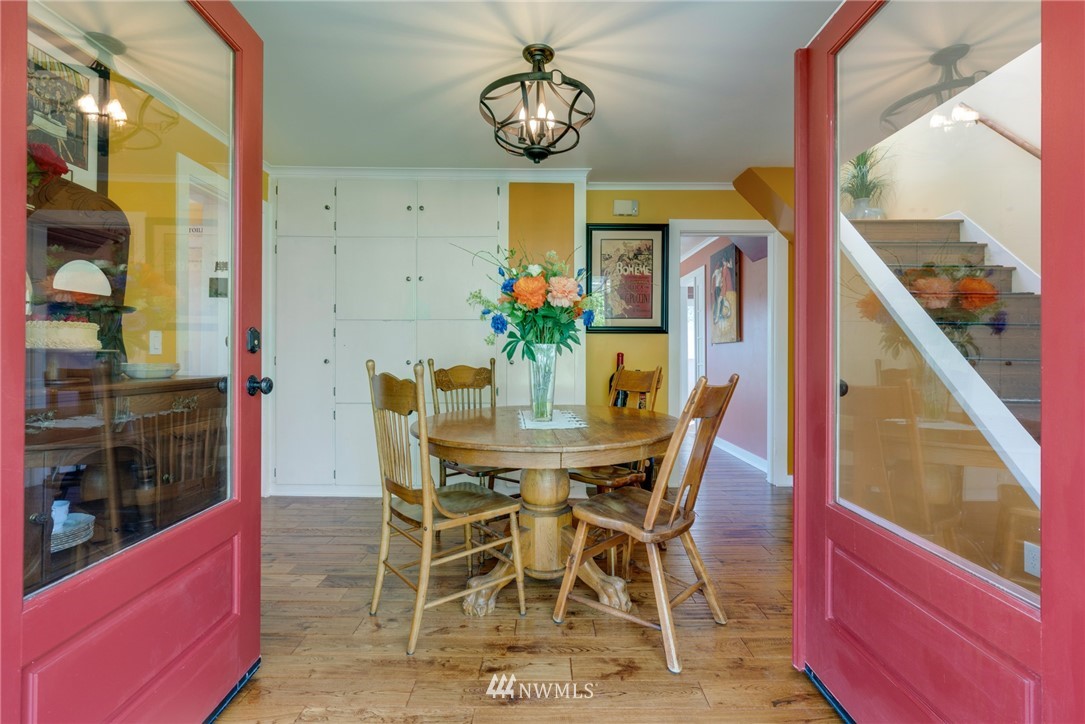 23908 24th Drive Southeast Bothell, WA 98021 - Photo 11 of 40 a view of a dining room with furniture a chandelier and wooden floor