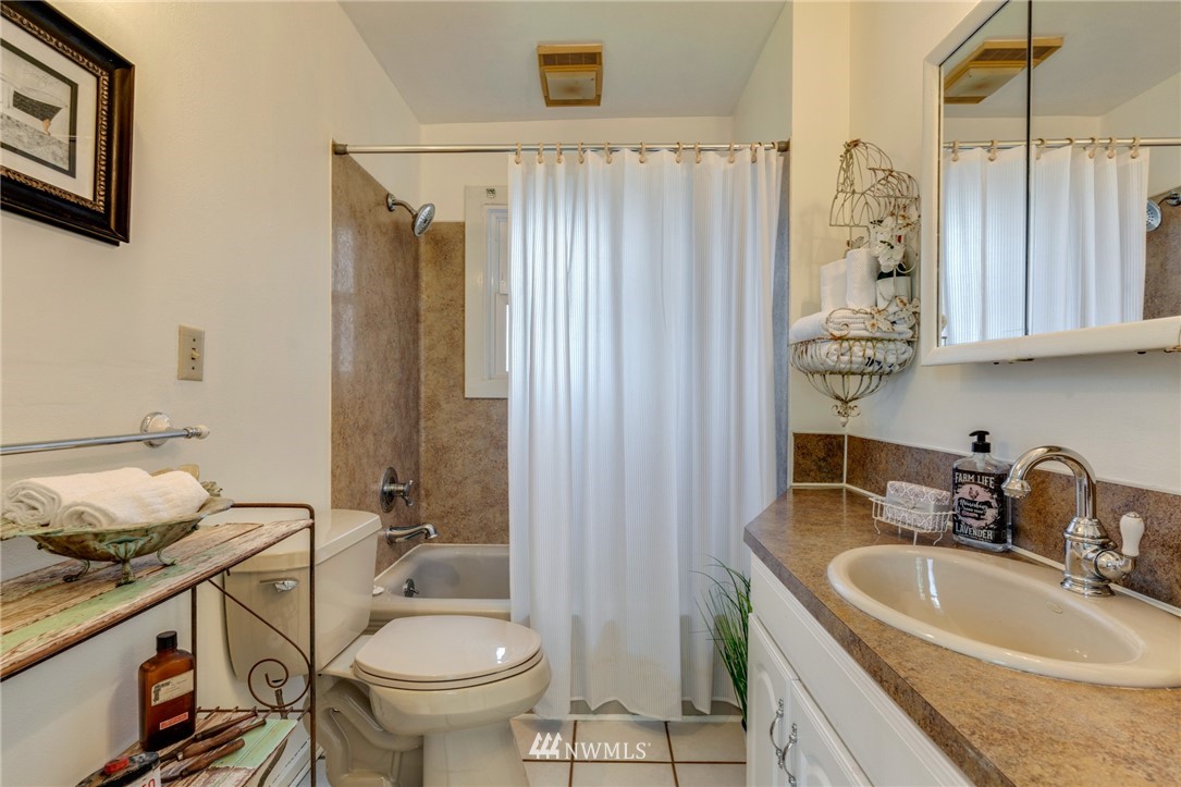 23908 24th Drive Southeast Bothell, WA 98021 - Photo 12 of 40 a bathroom with a sink a toilet and shower curtain