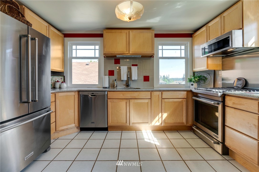 23908 24th Drive Southeast Bothell, WA 98021 - Photo 5 of 40 a kitchen with a sink a stove a refrigerator and cabinets