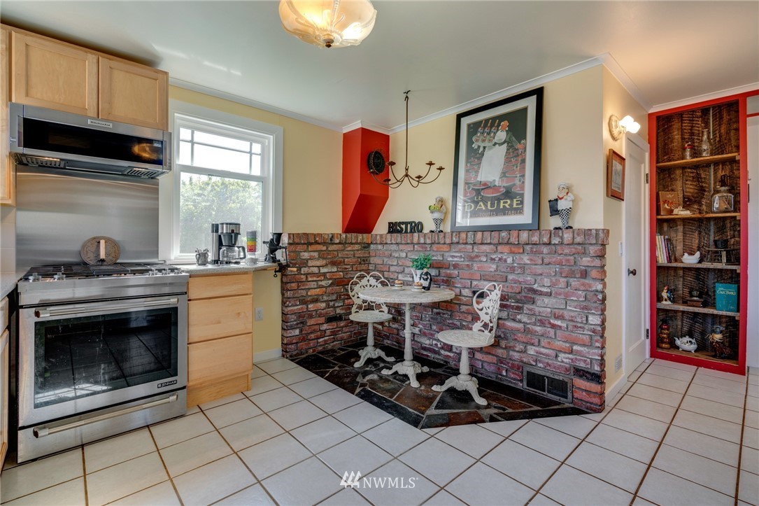 23908 24th Drive Southeast Bothell, WA 98021 - Photo 6 of 40 a kitchen with granite countertop a stove a sink and a microwave
