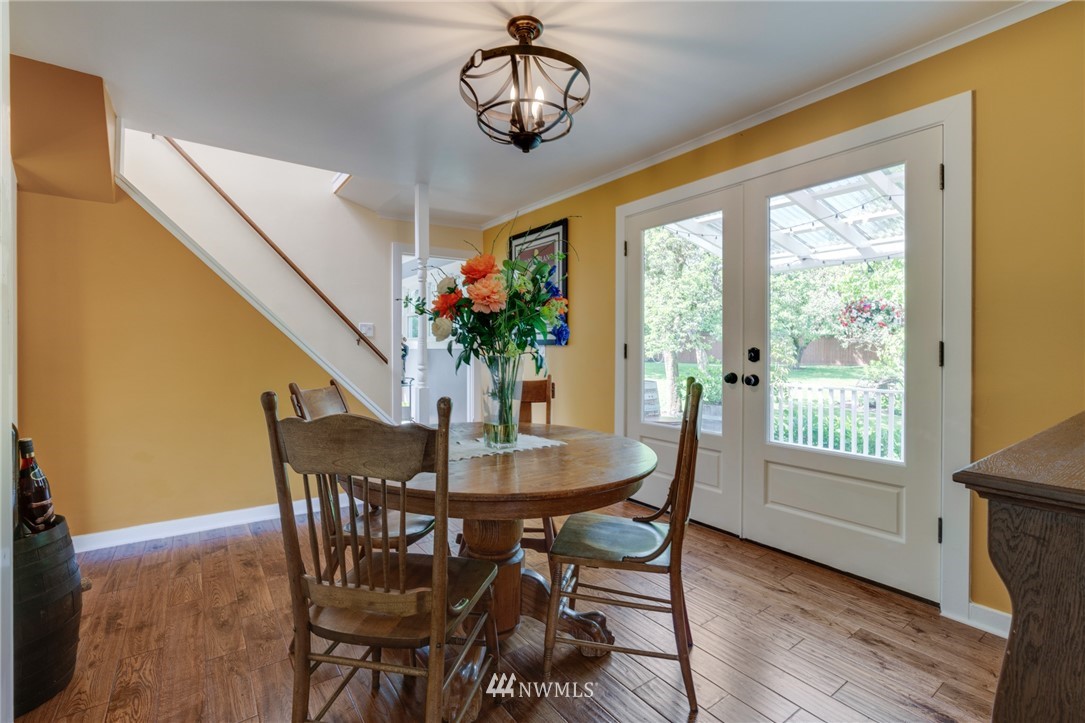 23908 24th Drive Southeast Bothell, WA 98021 - Photo 9 of 40 a dining room with furniture potted plants and wooden floor