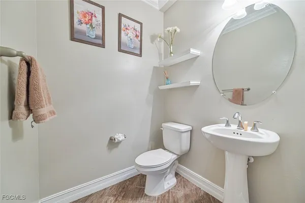 a bathroom with a sink mirror and toilet