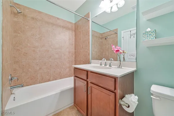 a bathroom with a sink vanity mirror and toilet