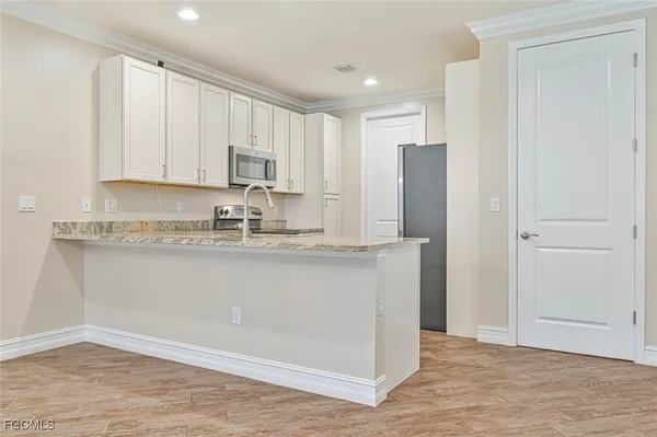 a kitchen with stainless steel appliances granite countertop a refrigerator sink and cabinets