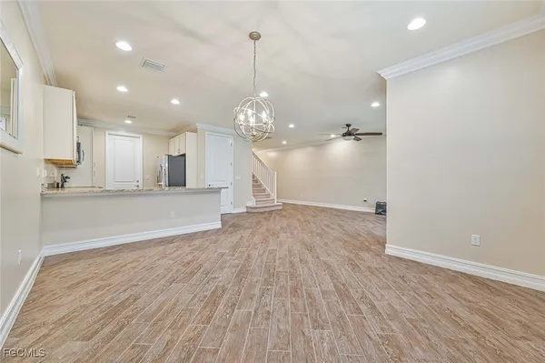 a view of a kitchen with wooden floor and a sink