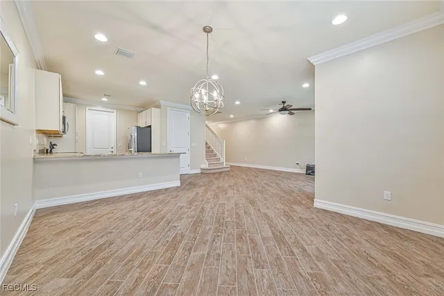 a view of a kitchen with wooden floor and a sink