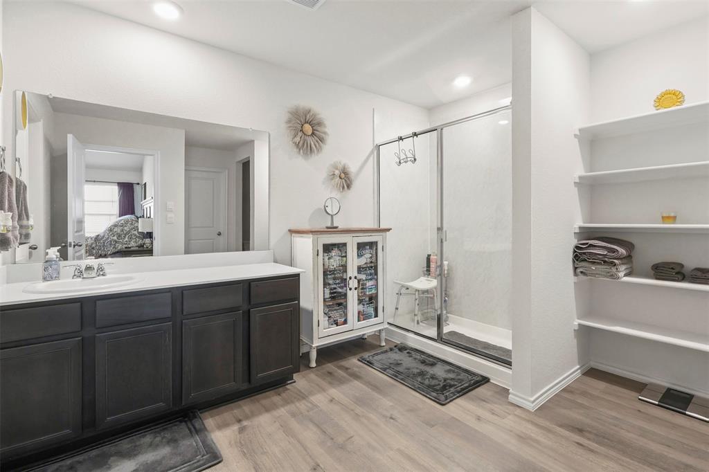 742 Buttercup Drive Pilot Point, TX 76258 - Photo 14 of 20 Bathroom featuring light wood-style floors, vanity, a stall shower, and ensuite bath