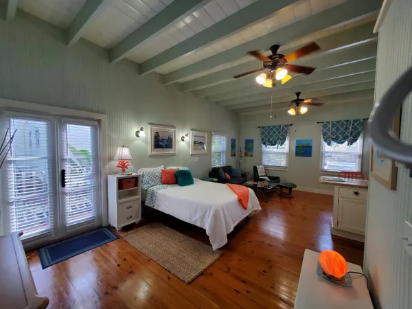 a bed room with a bed window and a chandelier
