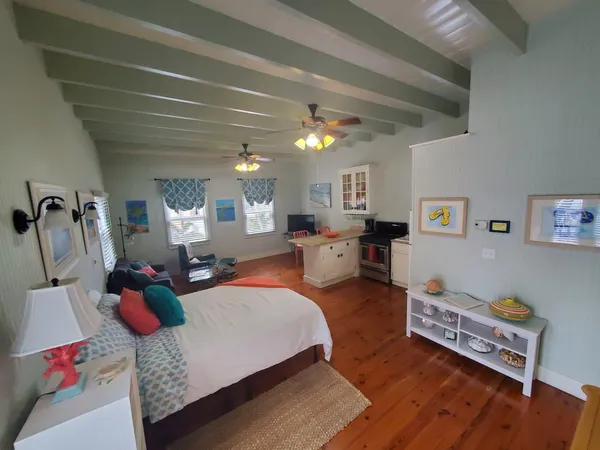 a bedroom with furniture and a wooden floor