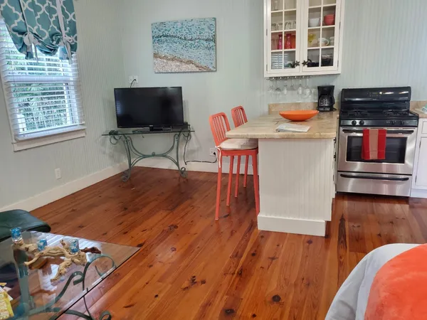 a reading room with wooden floor and furniture