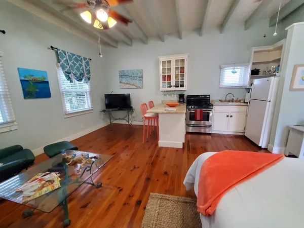 a bed room with a bed furniture and a flat tv screen