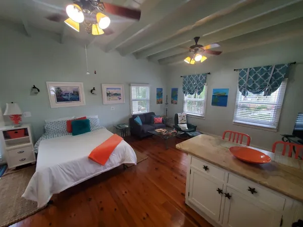 a bedroom with a bed window and dresser