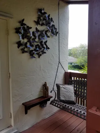a view of a hallway with wooden floor and a potted plant