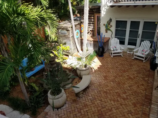 a view of a chairs and table in a patio